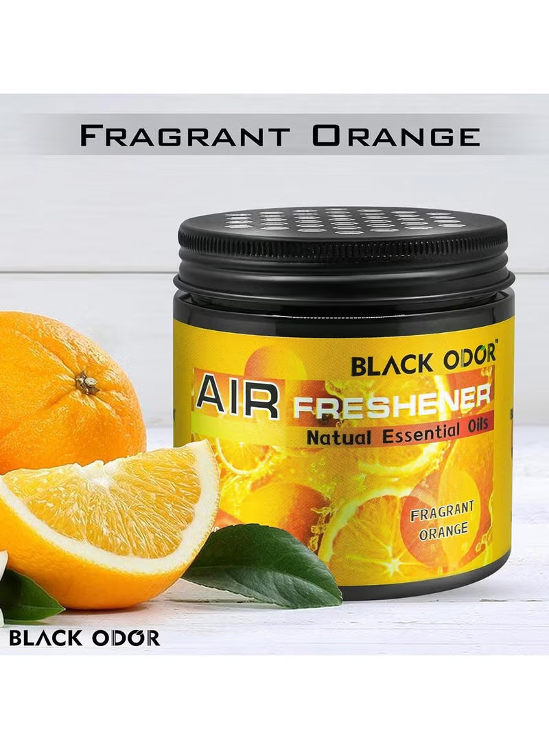 Black Odor air freshener with fragrant orange scent, surrounded by oranges and leaves on a white background.