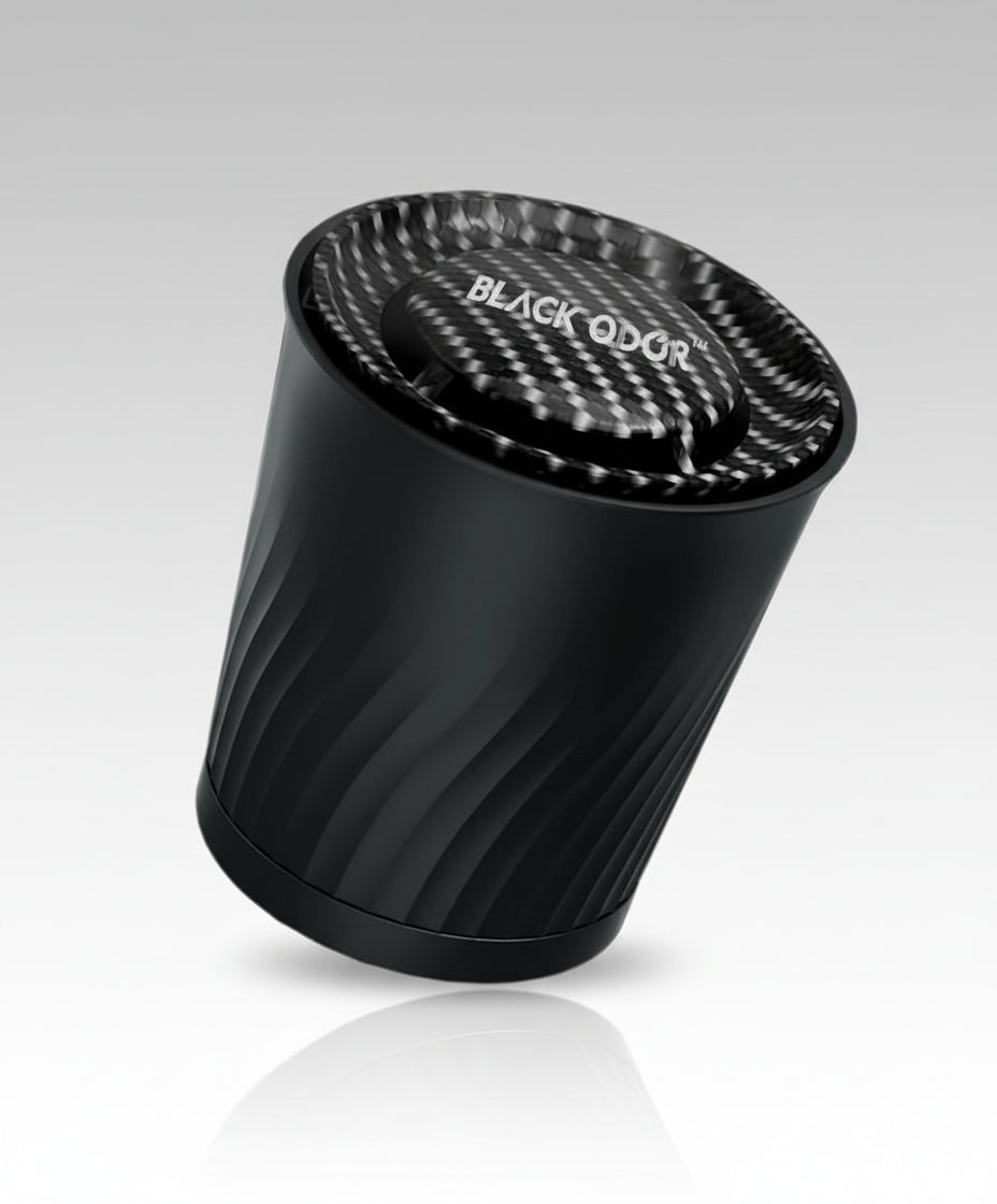 Black cylindrical air freshener with 'BLACK QDOR' branding on a white background