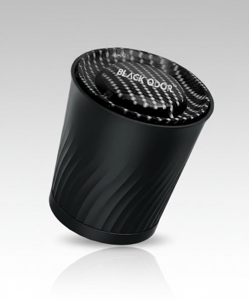 Black cylindrical air freshener with 'BLACK QDOR' branding on a white background