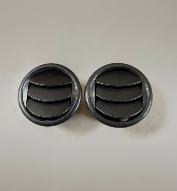 Two black circular objects on a gray background