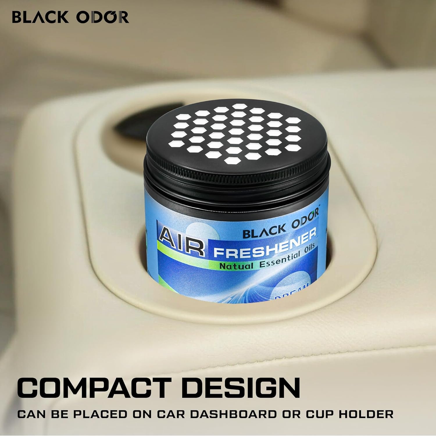 Air freshener canister in a car cup holder with 'Black Odor' branding.