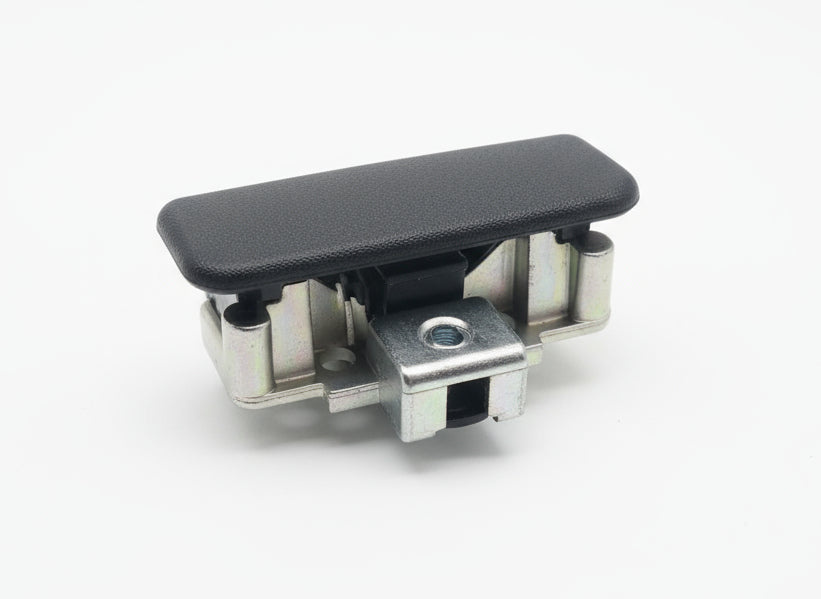 Black mechanical component on a wooden surface