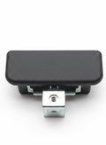 Black textured object with a metallic component on a wooden surface