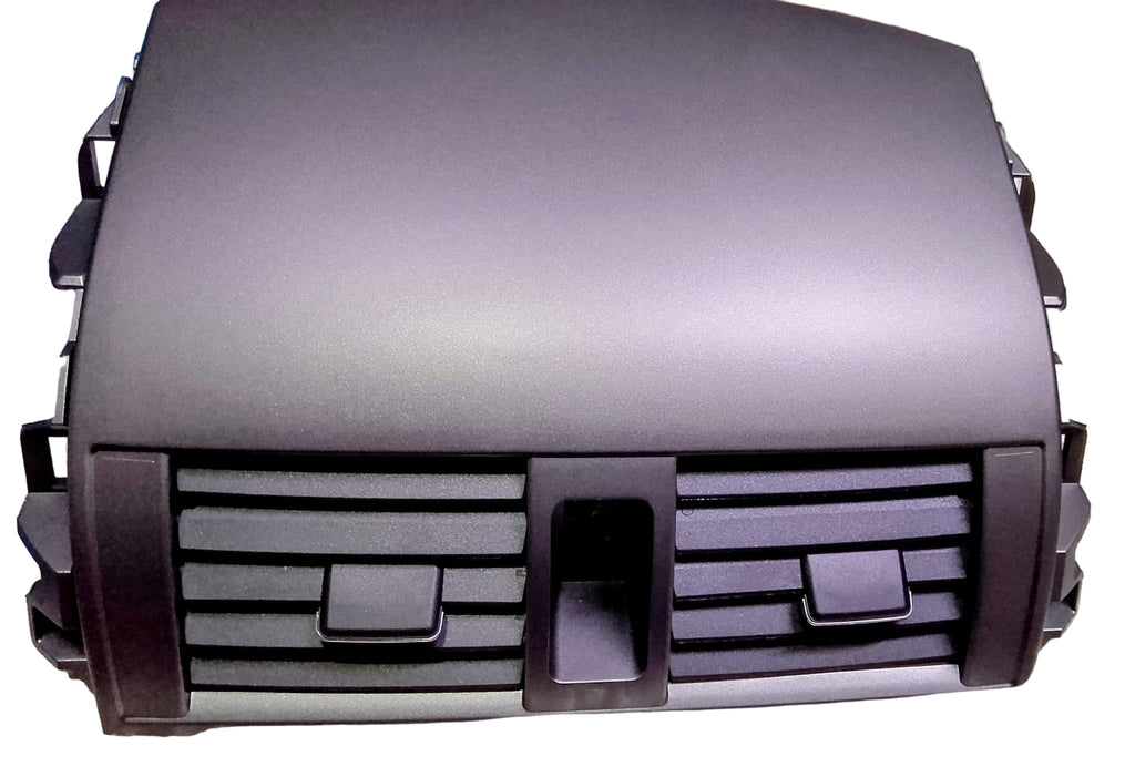 Car grille on a reflective surface with a blurred background