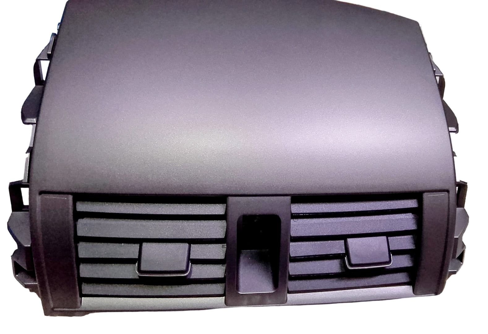 Car grille on a reflective surface with a blurred background