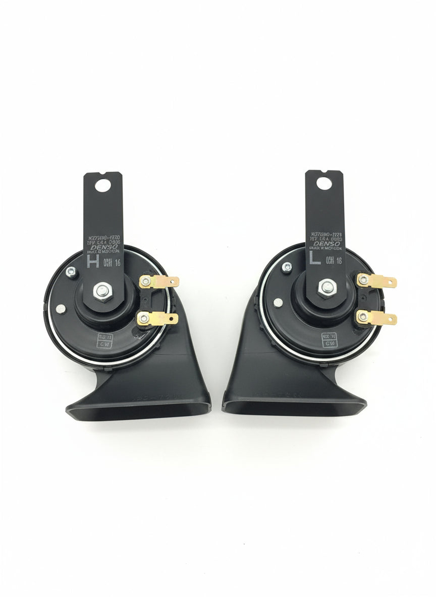 Two car speakers on a wooden floor
