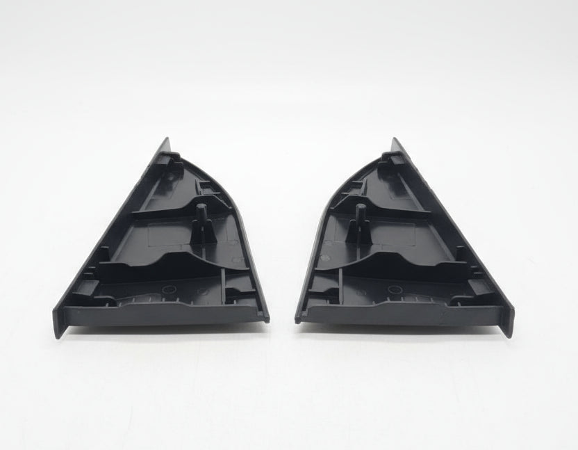 Two black plastic corner brackets on a textured surface