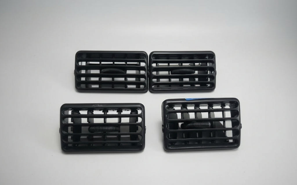 Four black car grills on a white background