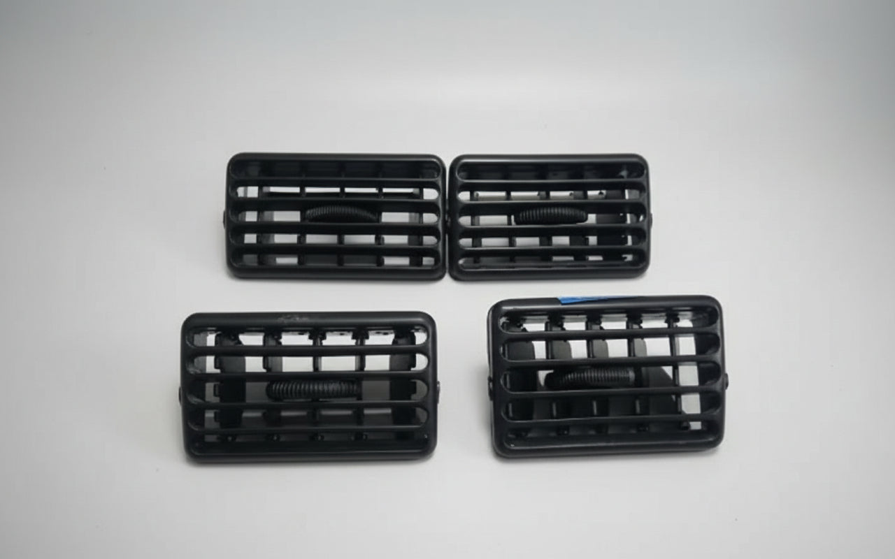 Four black car grills on a white background