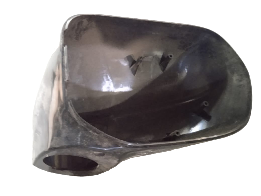 Black plastic component on a white surface