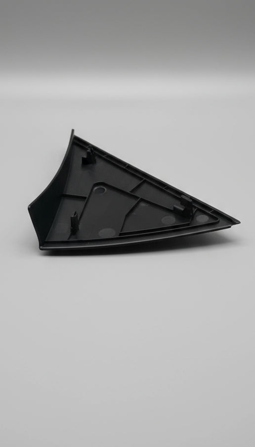 Black triangular rubber mat on a cardboard surface