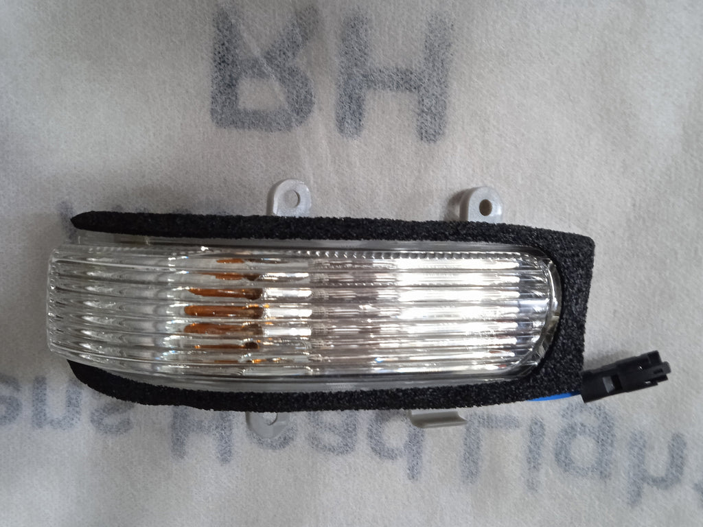 Car side marker light on a white background with text