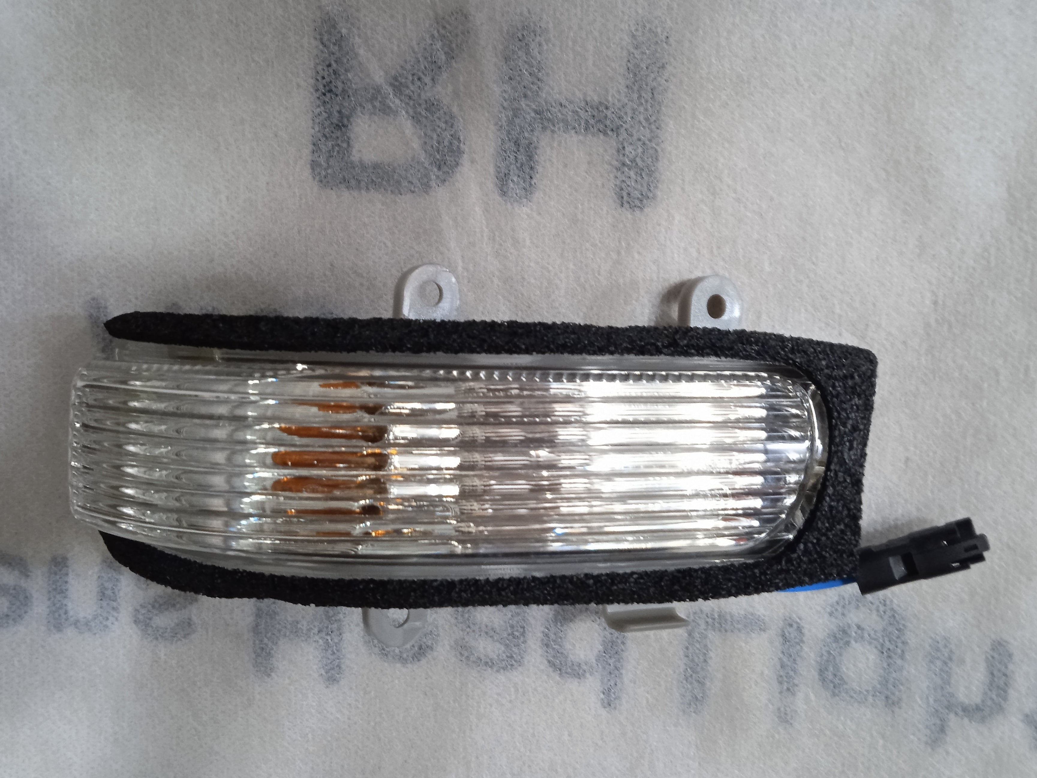 Car side marker light on a white background with text