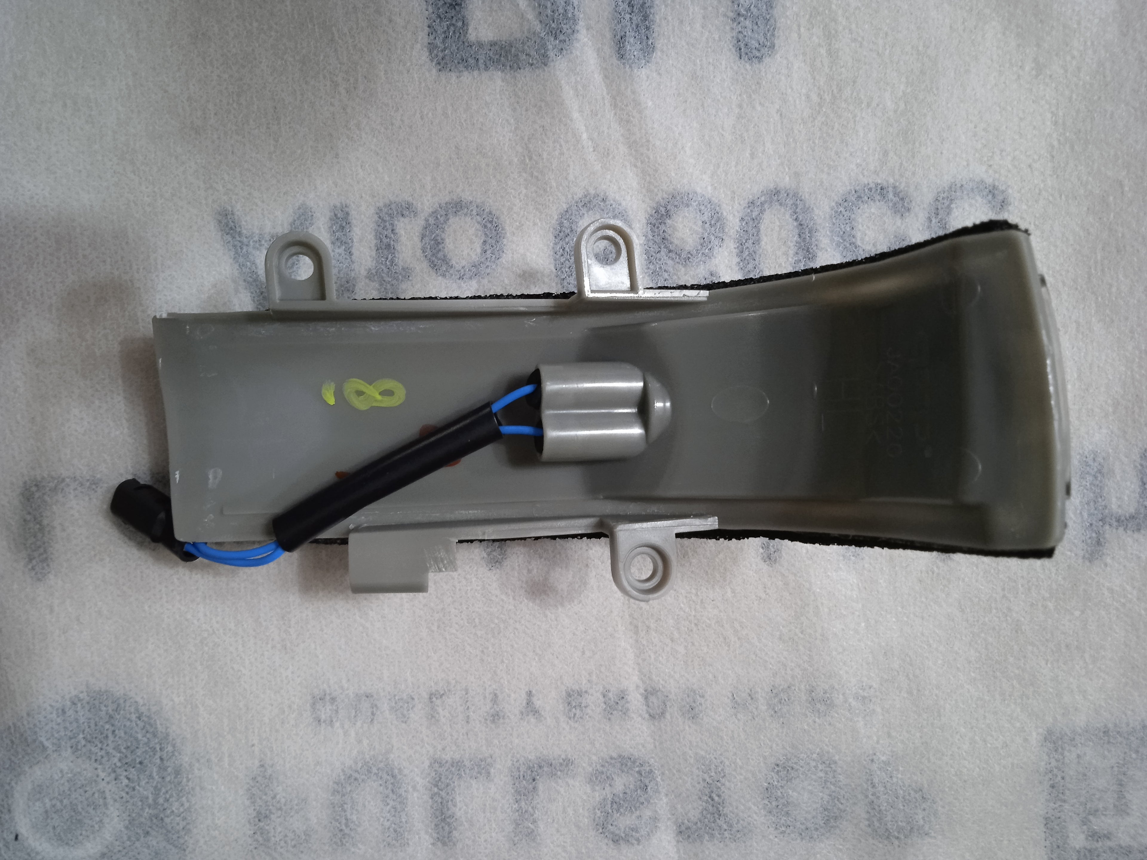 Mechanical component on a gray background with text