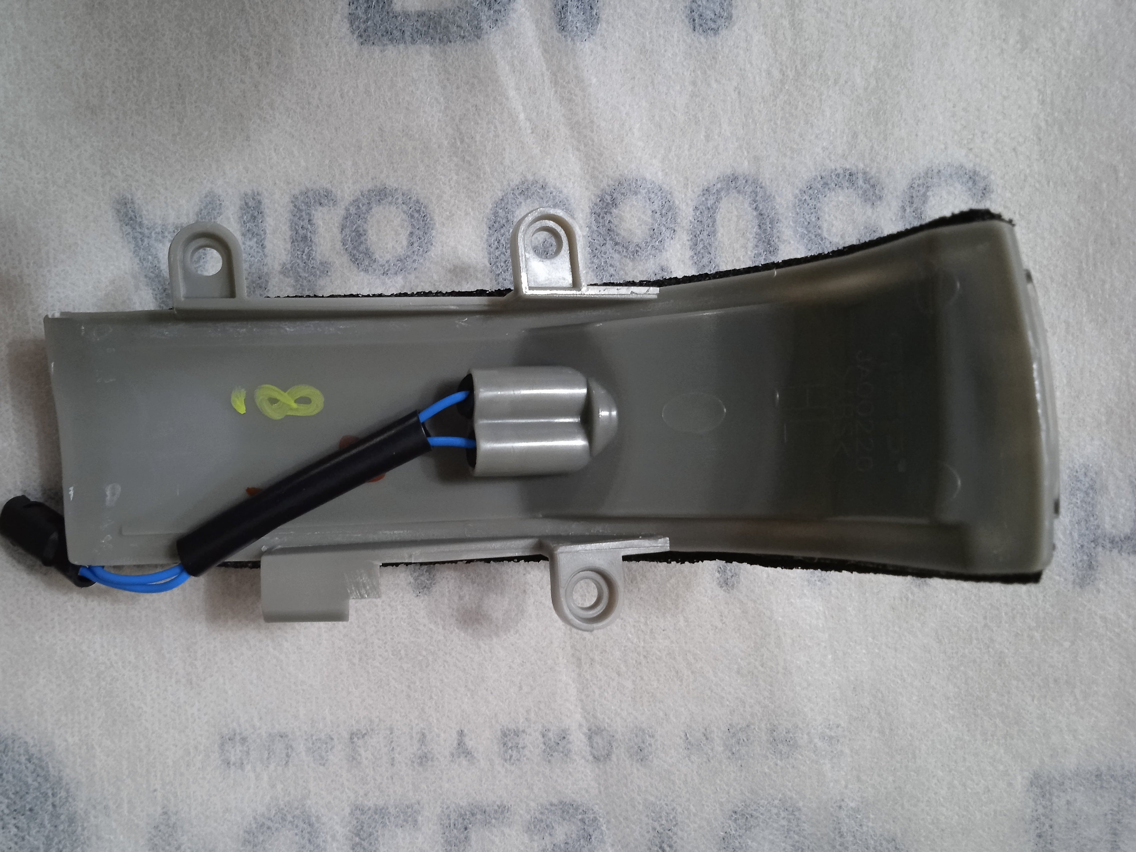 Mechanical component on a gray background with text