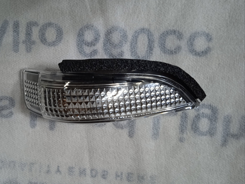 Car fog light cover on a textured gray background