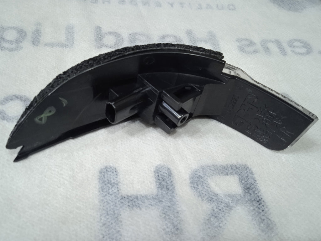 Car windshield wiper blade on a white surface with text