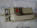 Beige window handle on a textured surface with text