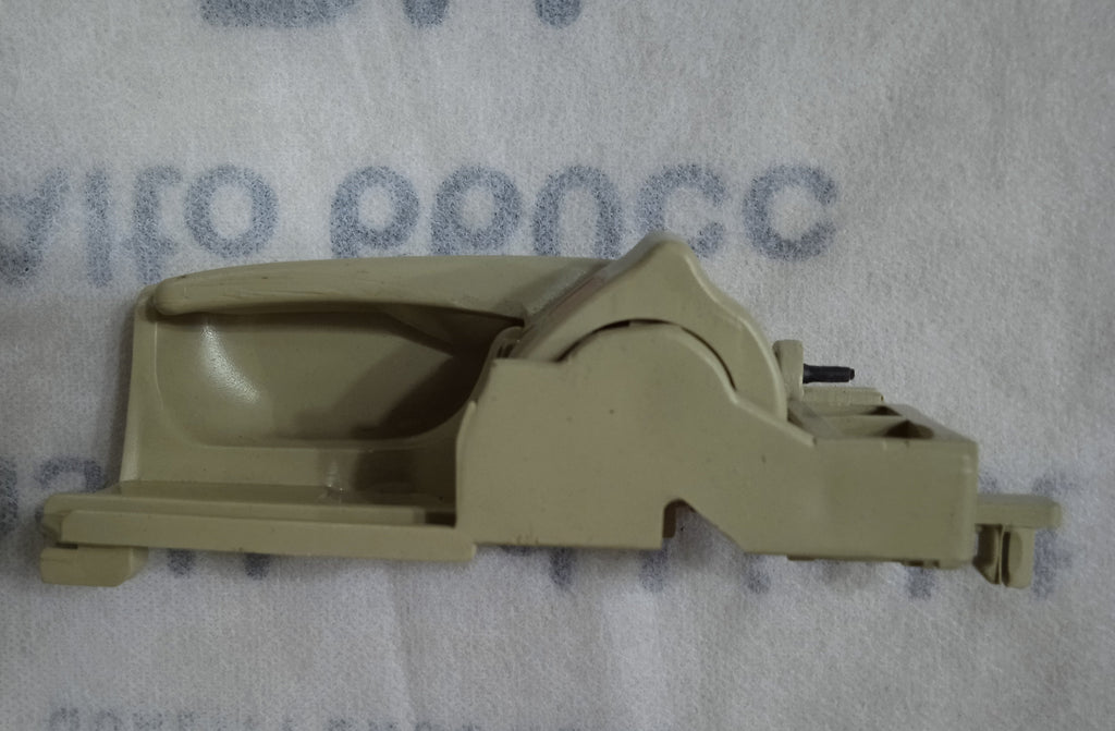 Beige car door handle on a gray background with text