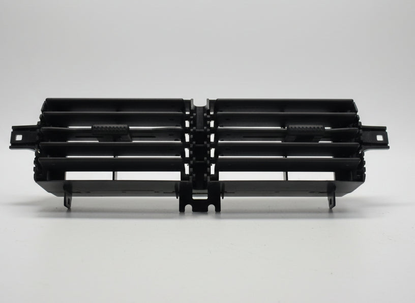 Black plastic component on a white surface