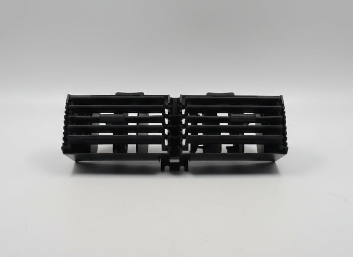 Black plastic component on a white surface