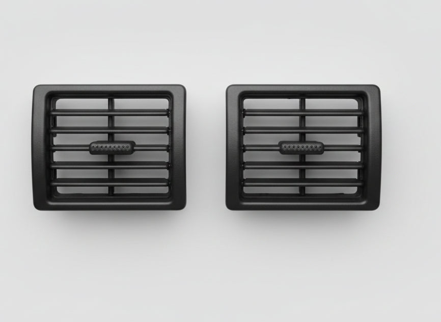Two black plastic grilles on a white surface