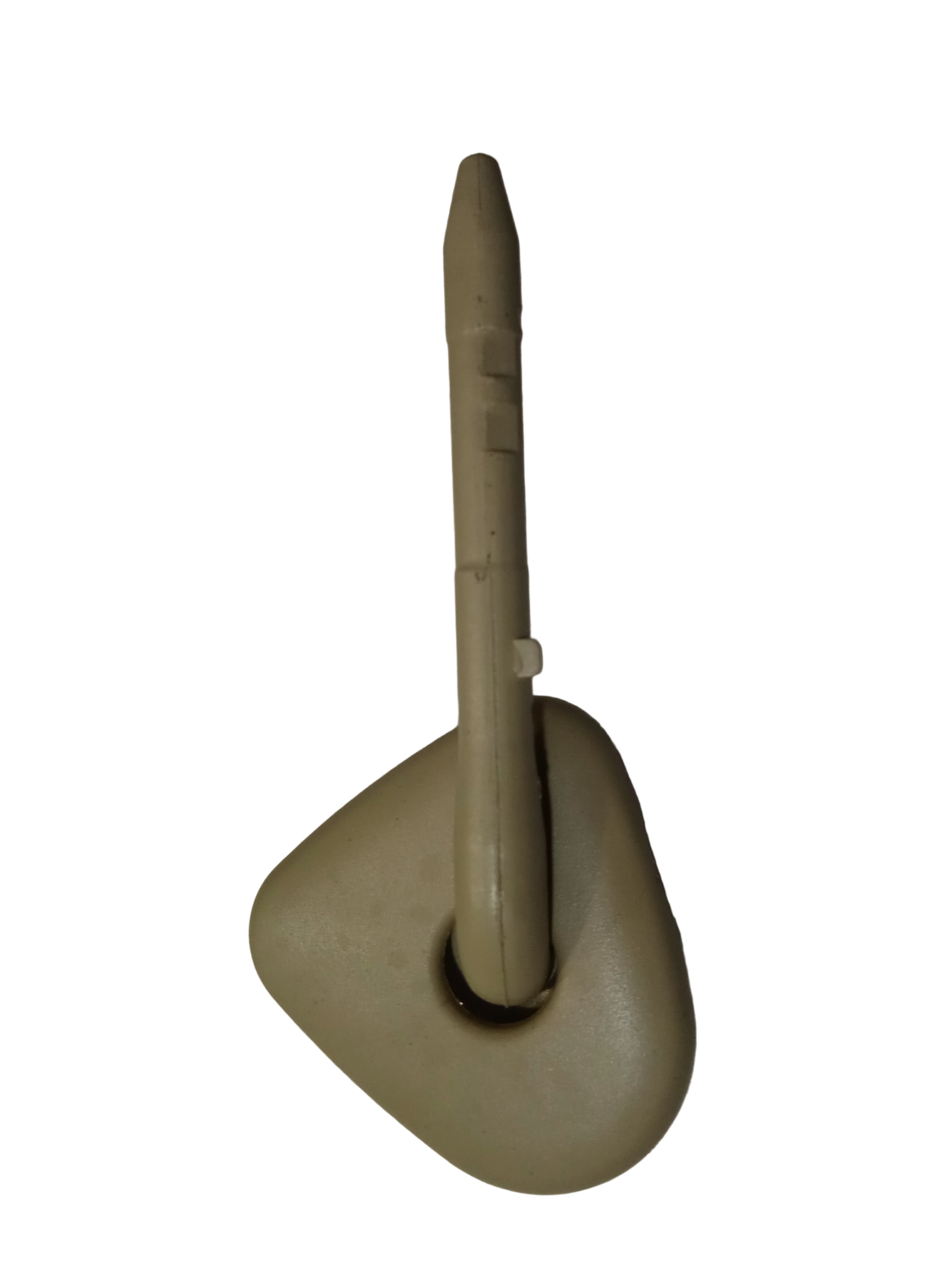 Beige plastic component on a white surface