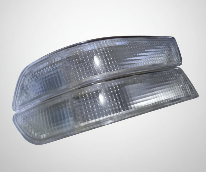 Two clear car side marker lights on a cardboard box