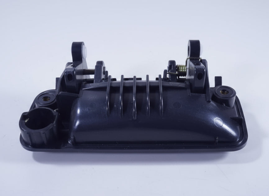 Black mechanical component on a beige surface with a red and white logo in the background