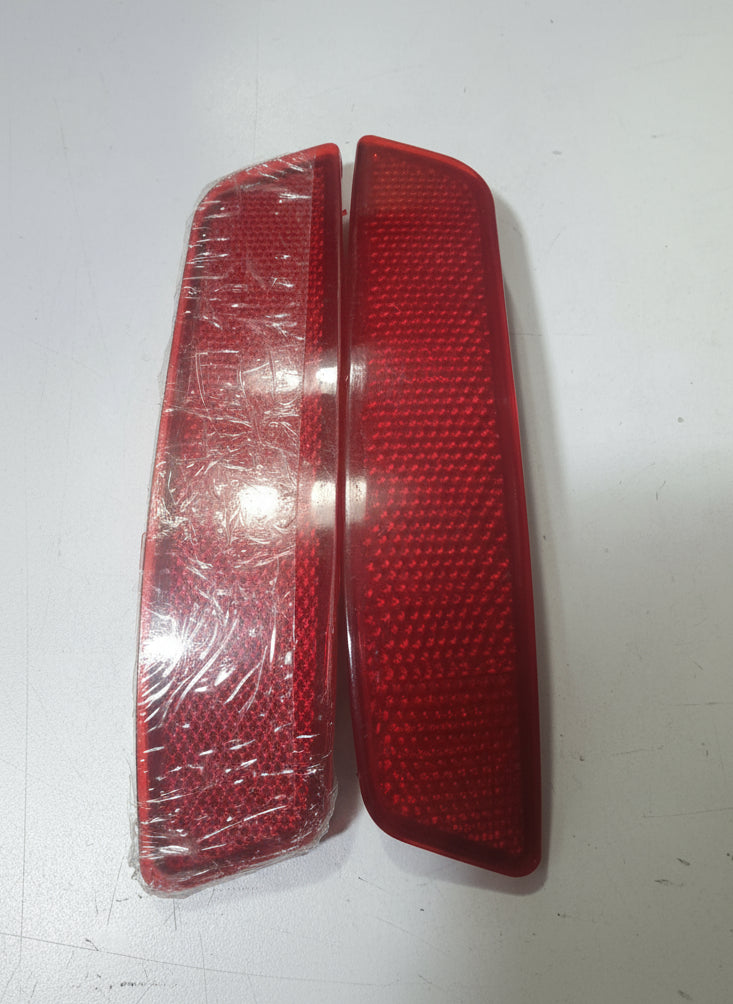 Two red reflective markers on a white background