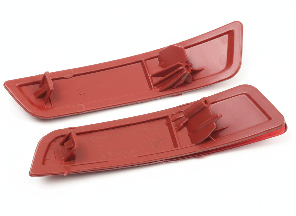 Two red plastic components on a white background