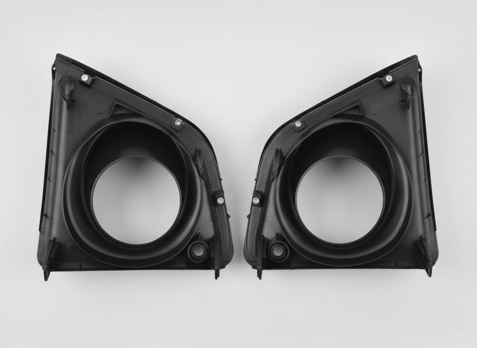 Two black car air filter housings on a white surface
