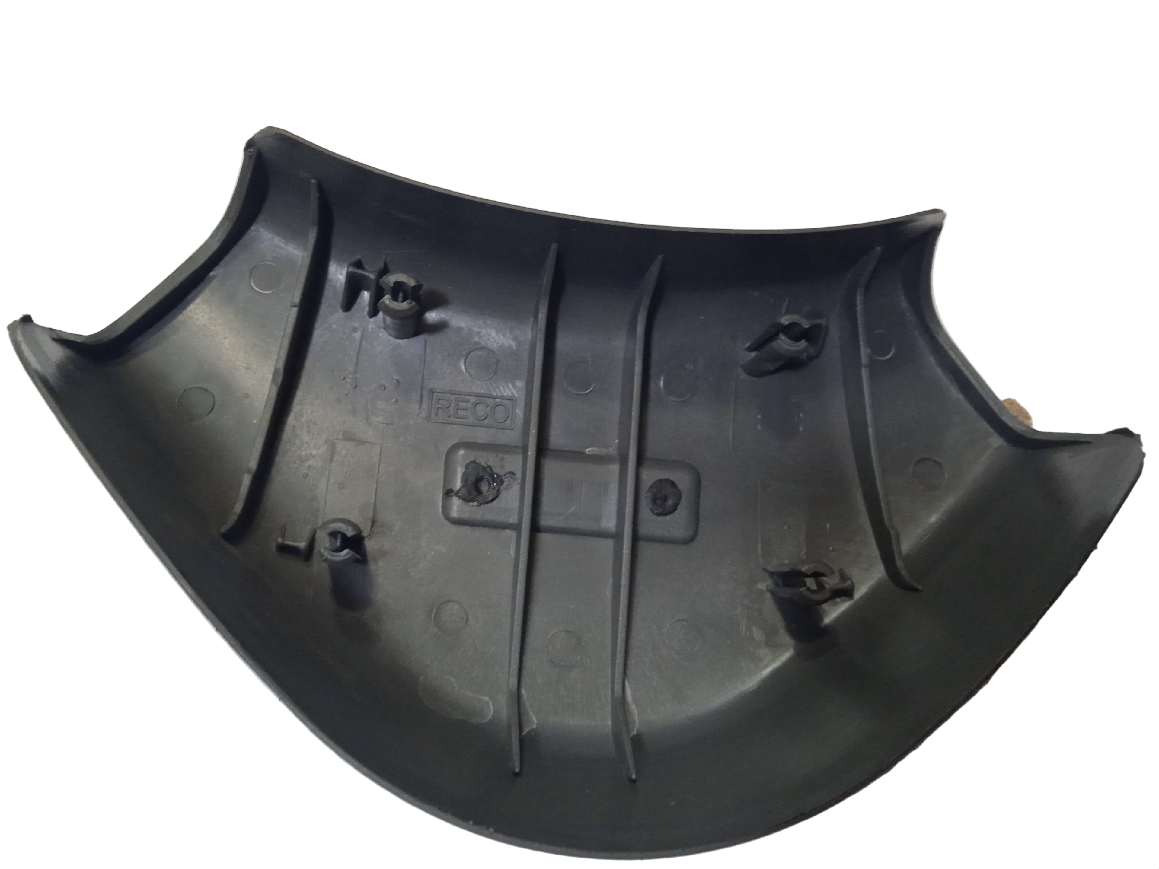 Black plastic car bumper on a white surface