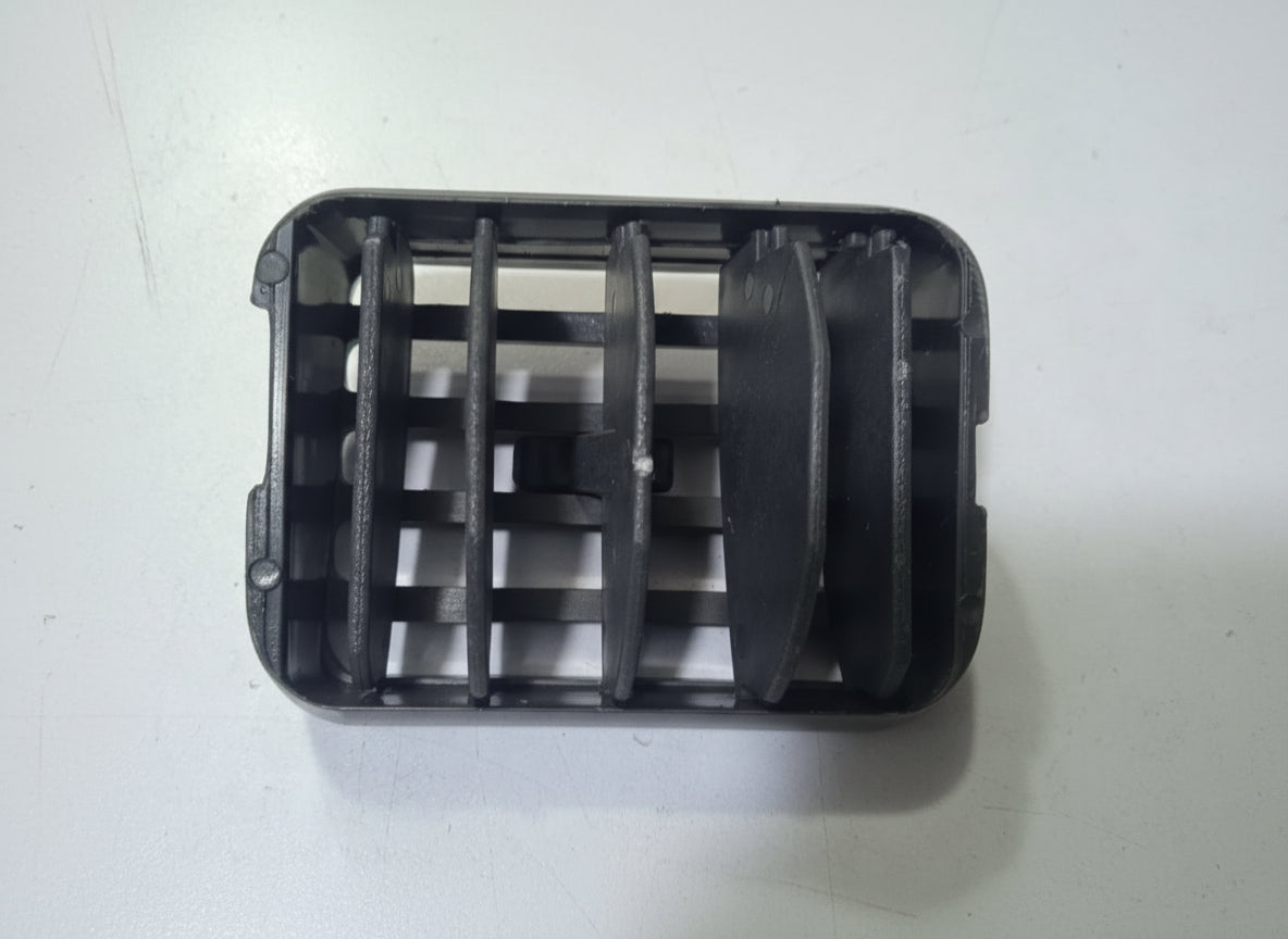 Black plastic component on a white background