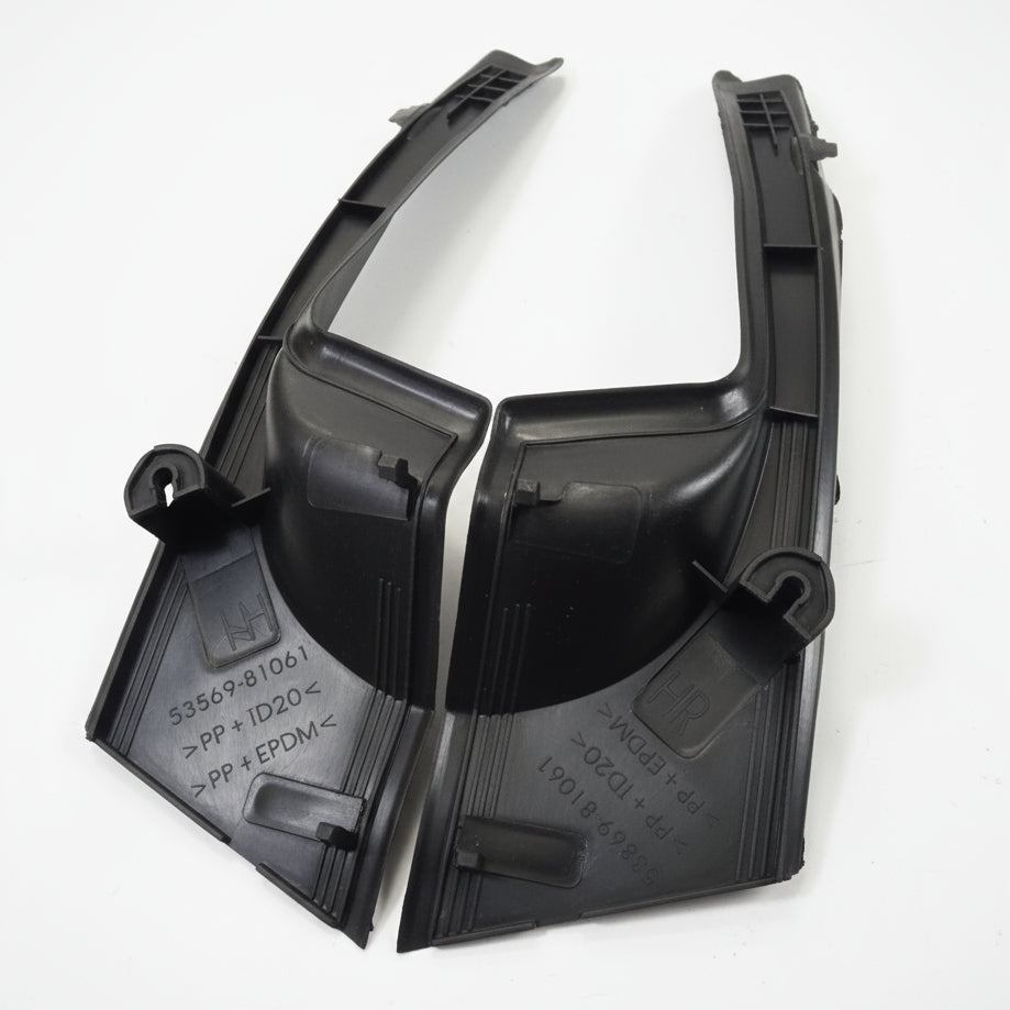 Black plastic car fender on a white surface