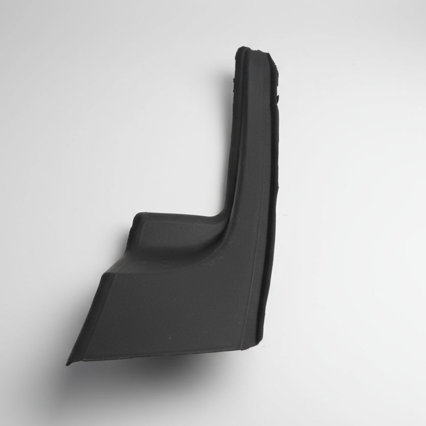 Black car interior panel on a white surface