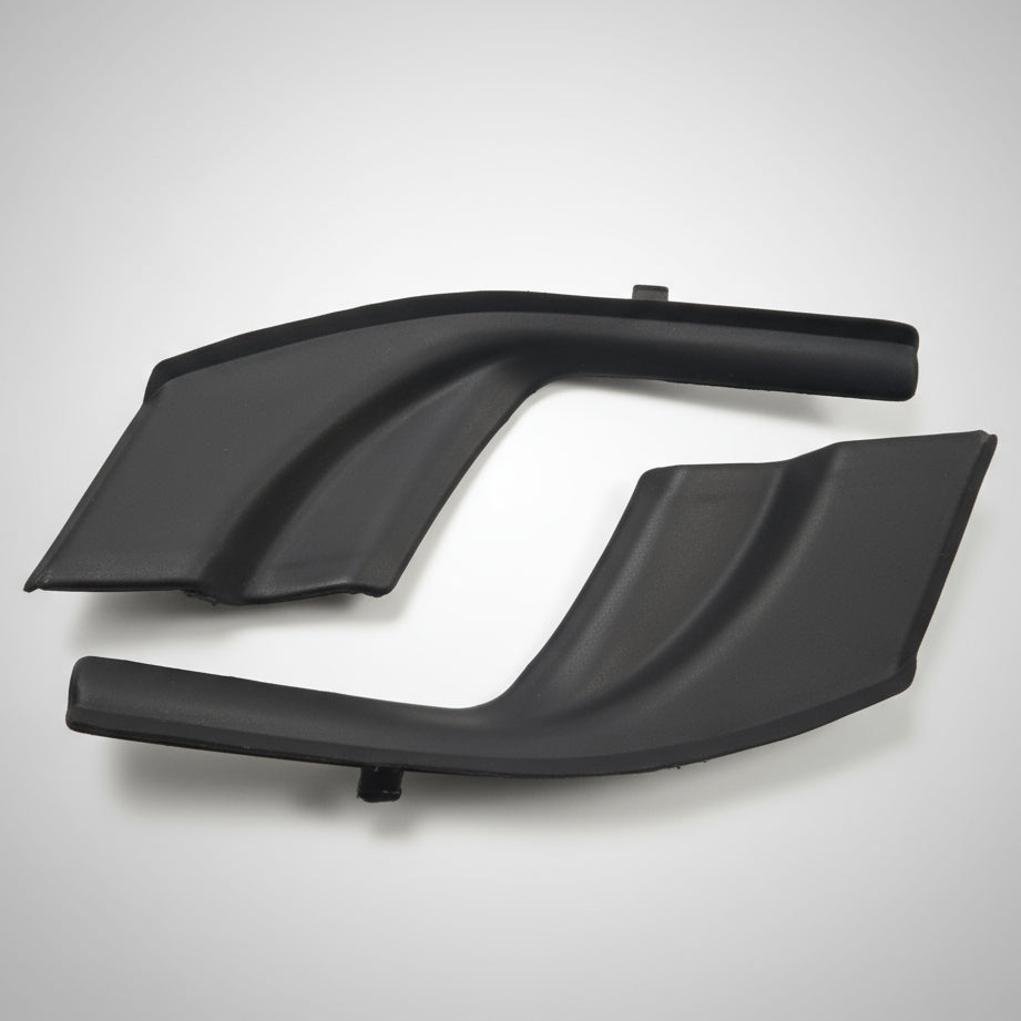 Black plastic car fender on a scratched metal surface