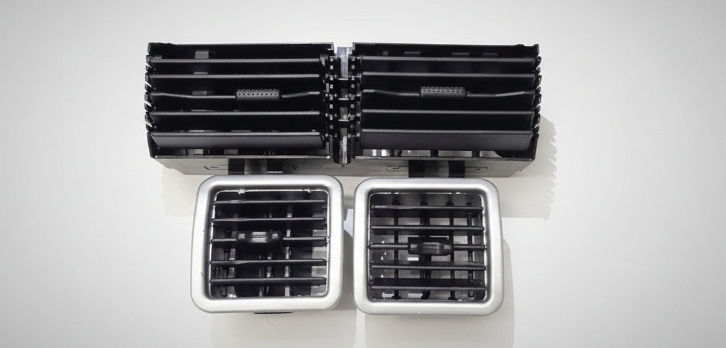 Set of black and silver air vents on a white surface