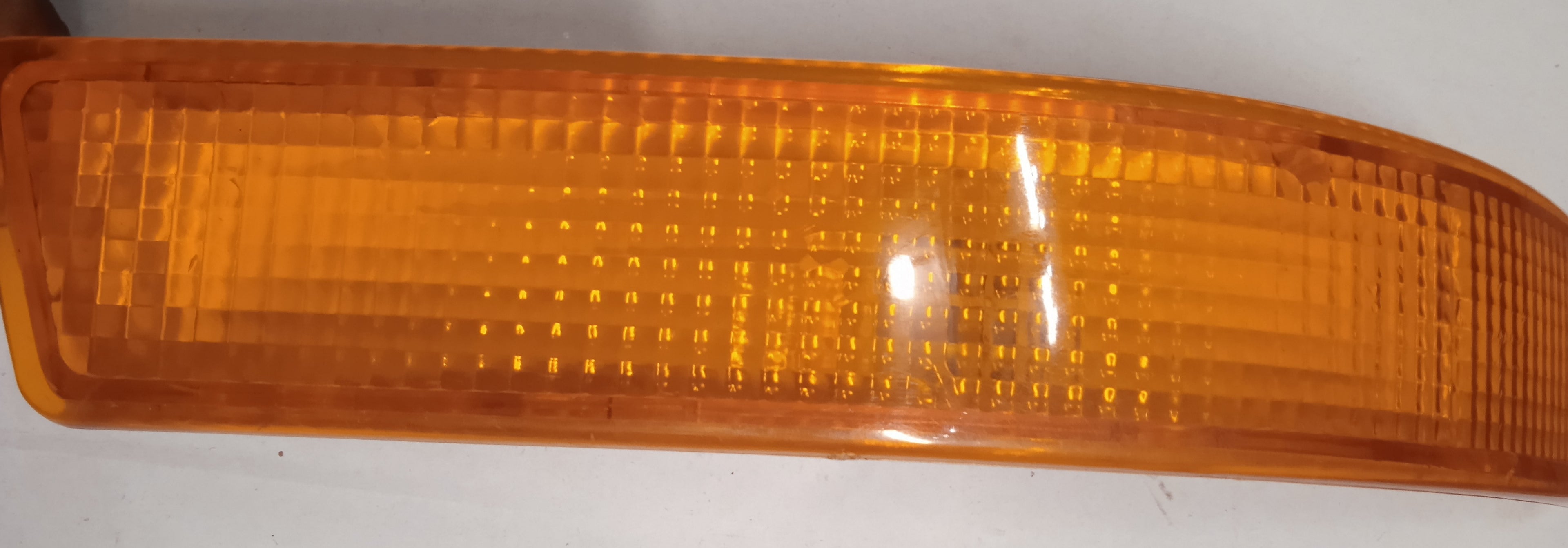 Amber car side marker light on a white background