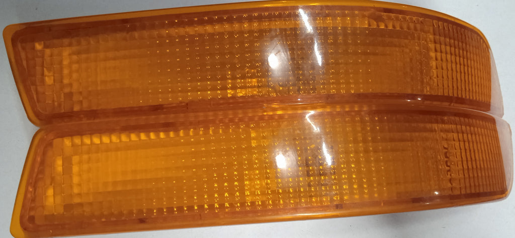 Two amber traffic lights on a white background