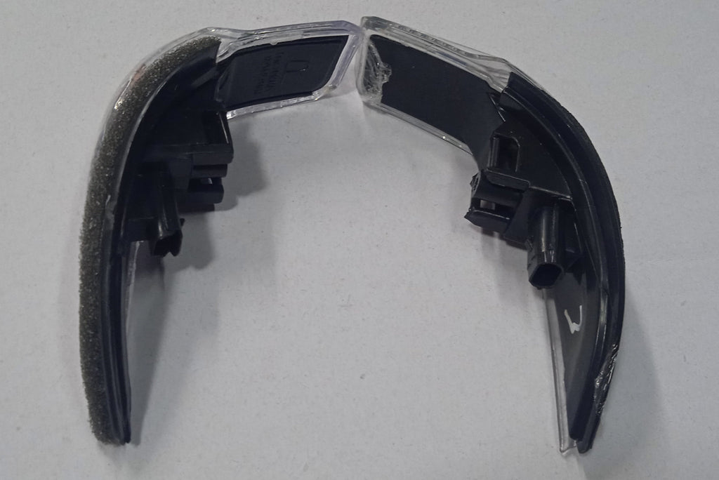 Black plastic component on a white background