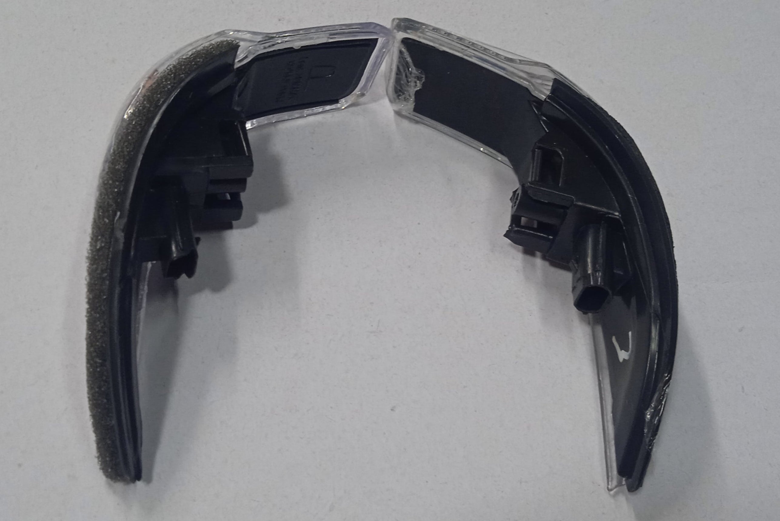 Black plastic component on a white background