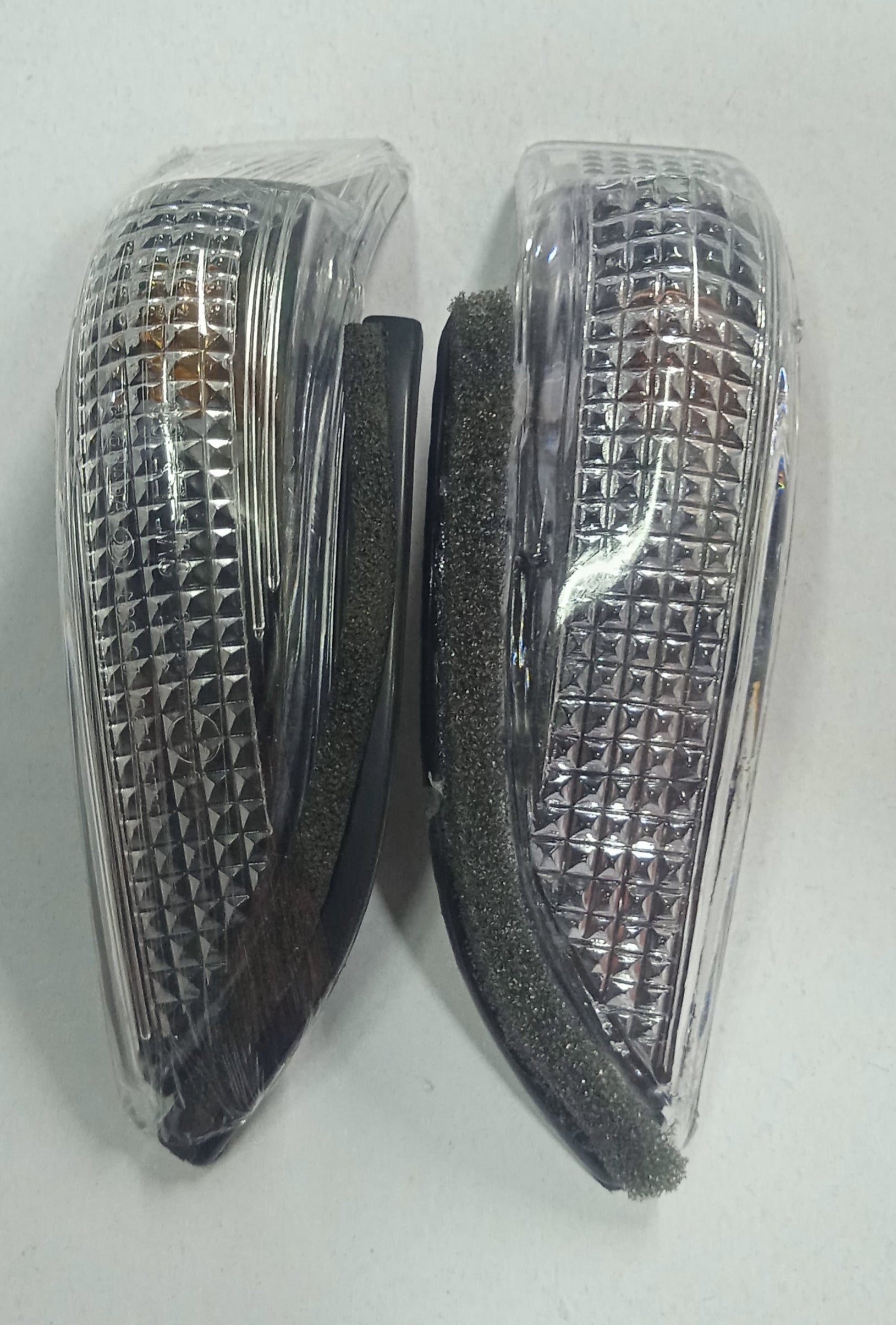 Two triangular reflective markers on a white background