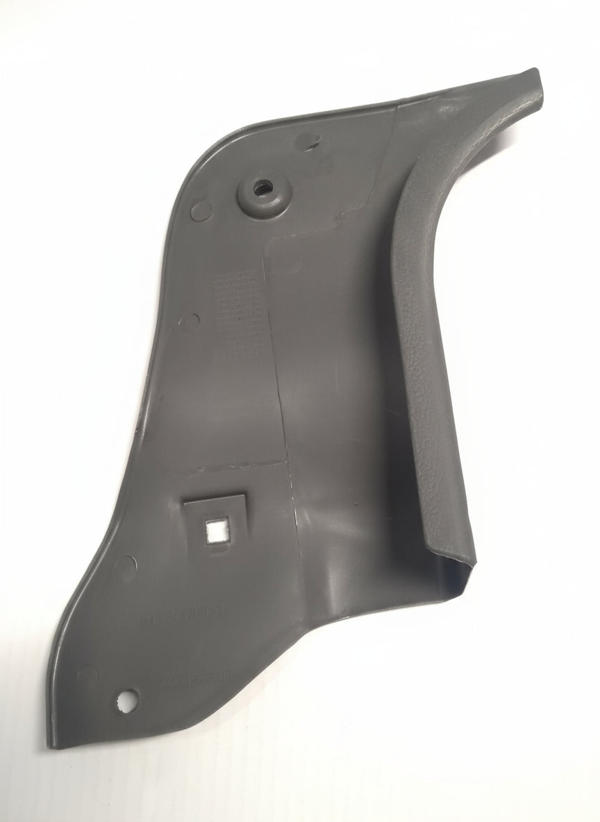 Black plastic car part on a tiled floor