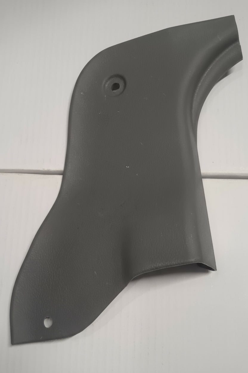 Black plastic car panel on a white tiled background