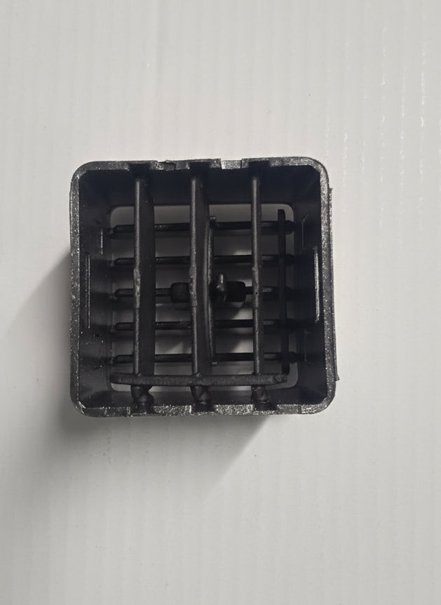 Black plastic component on a white background