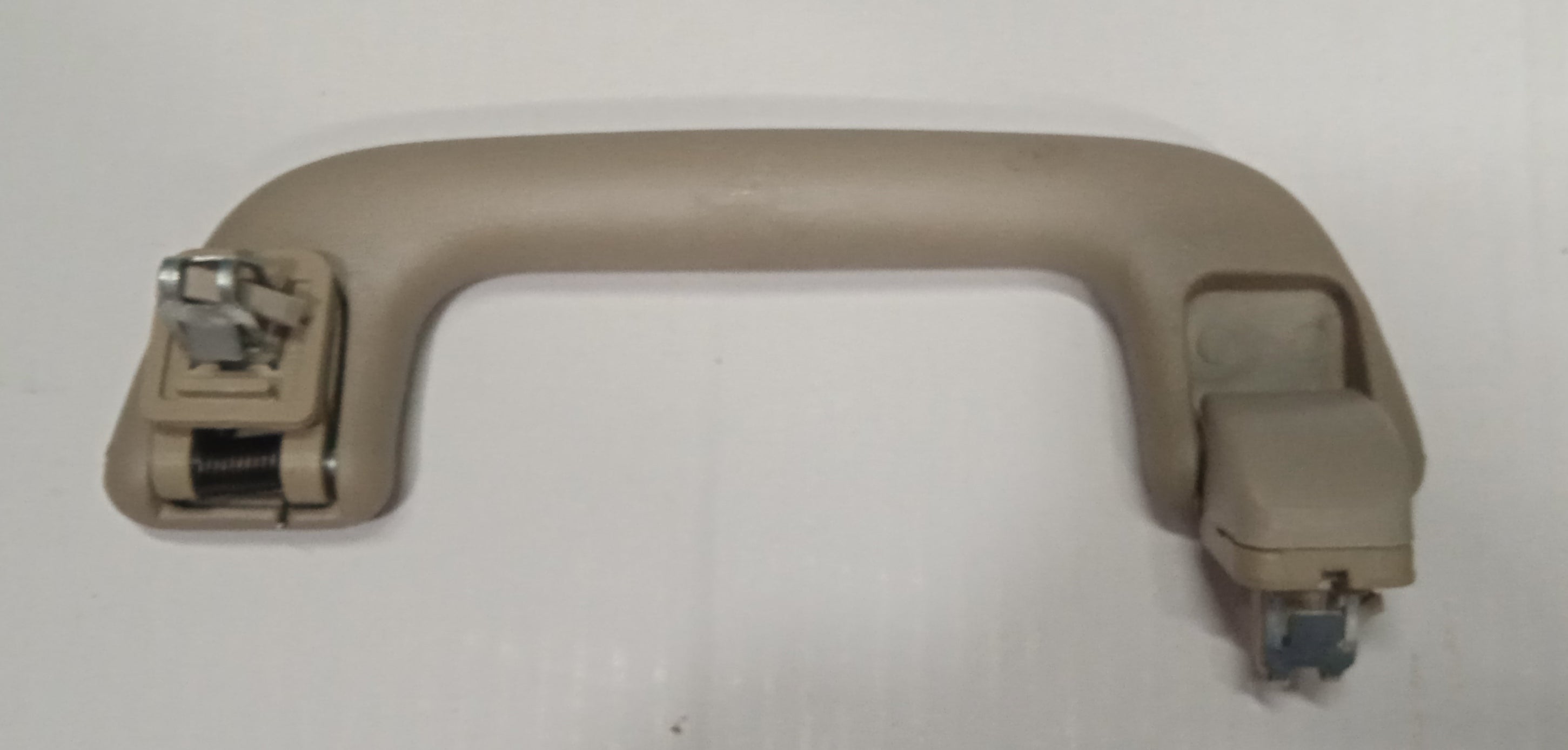 Beige car door handle on a white background