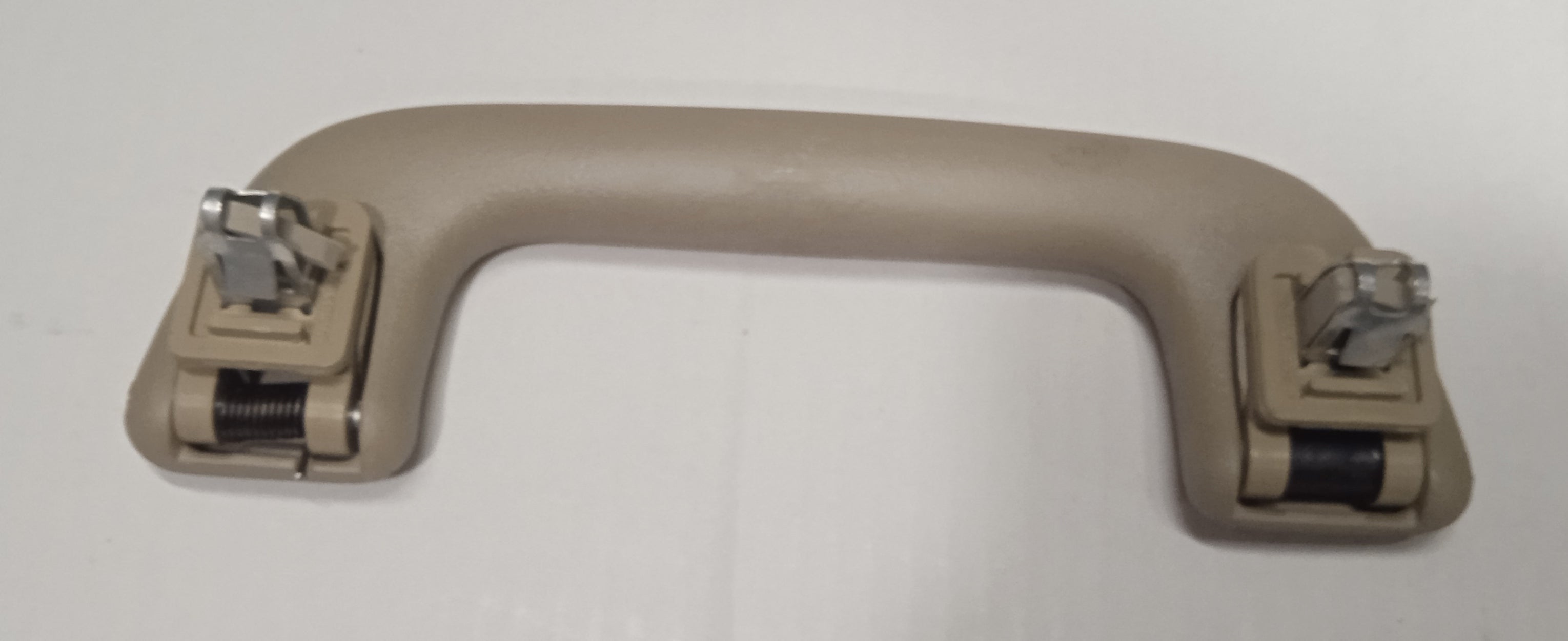Beige car door handle on a white background