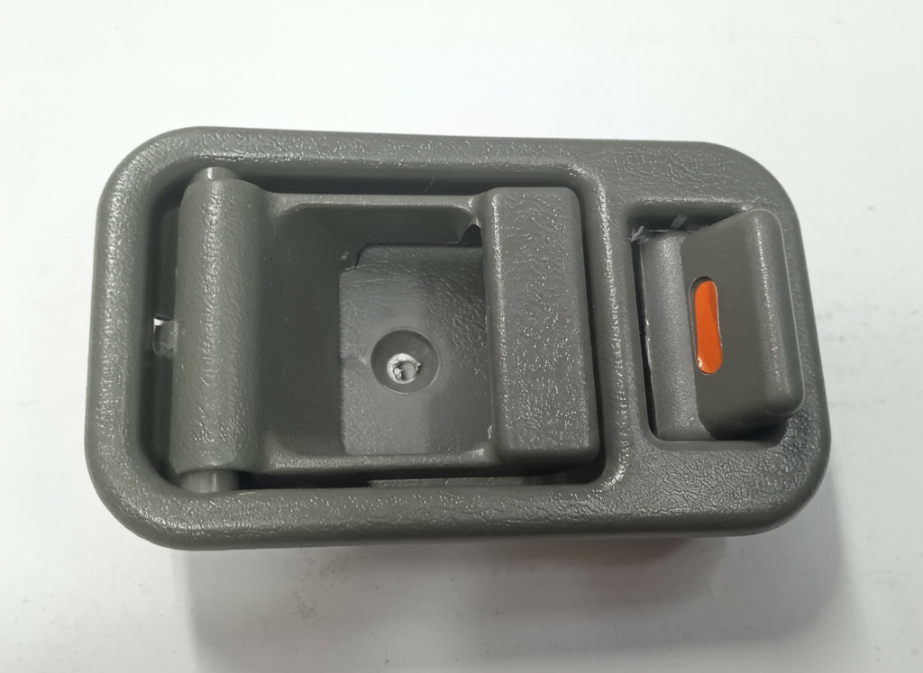 Gray car interior door handle with a red switch on a white background