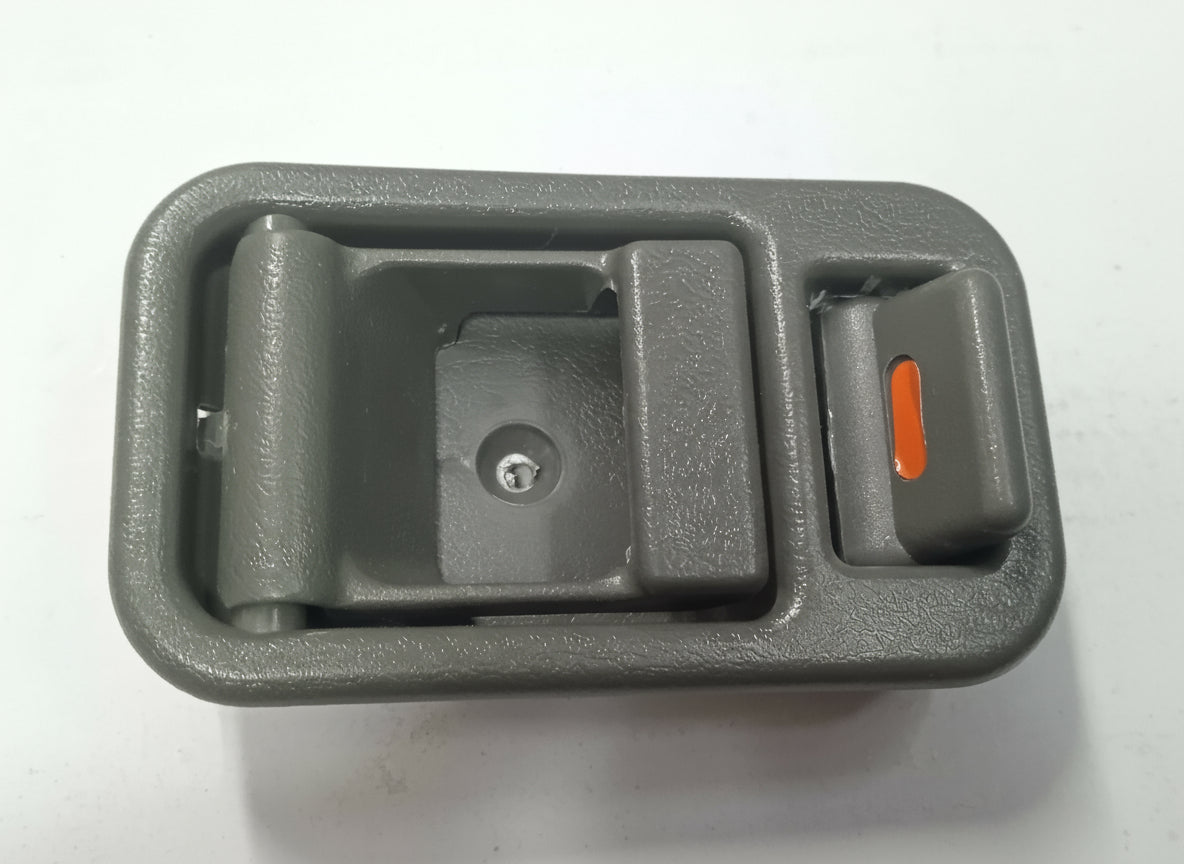 Gray car interior door handle with a red switch on a white background